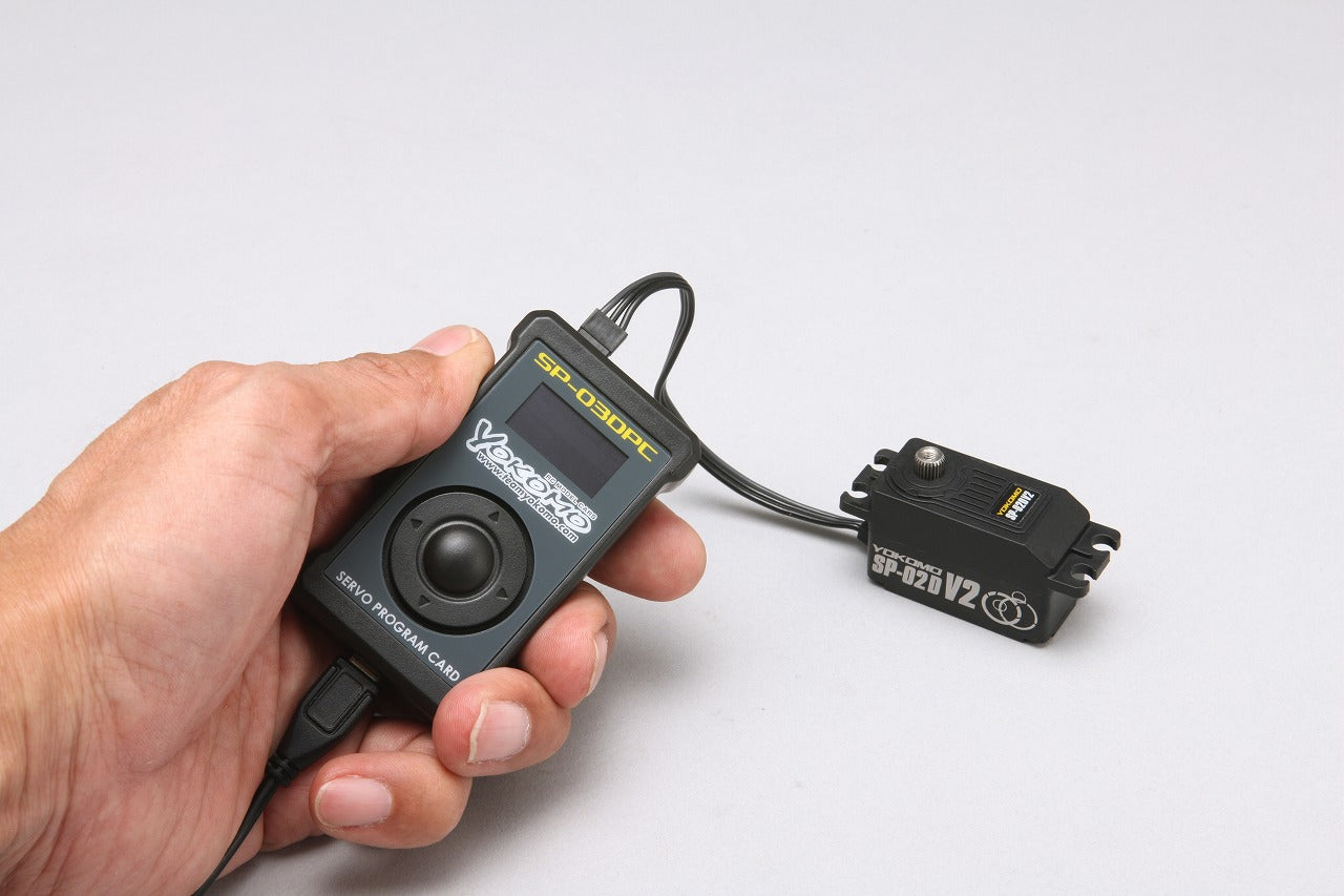 Digital Low Profile Coreless Servo V2 remote program card control in a persons hand