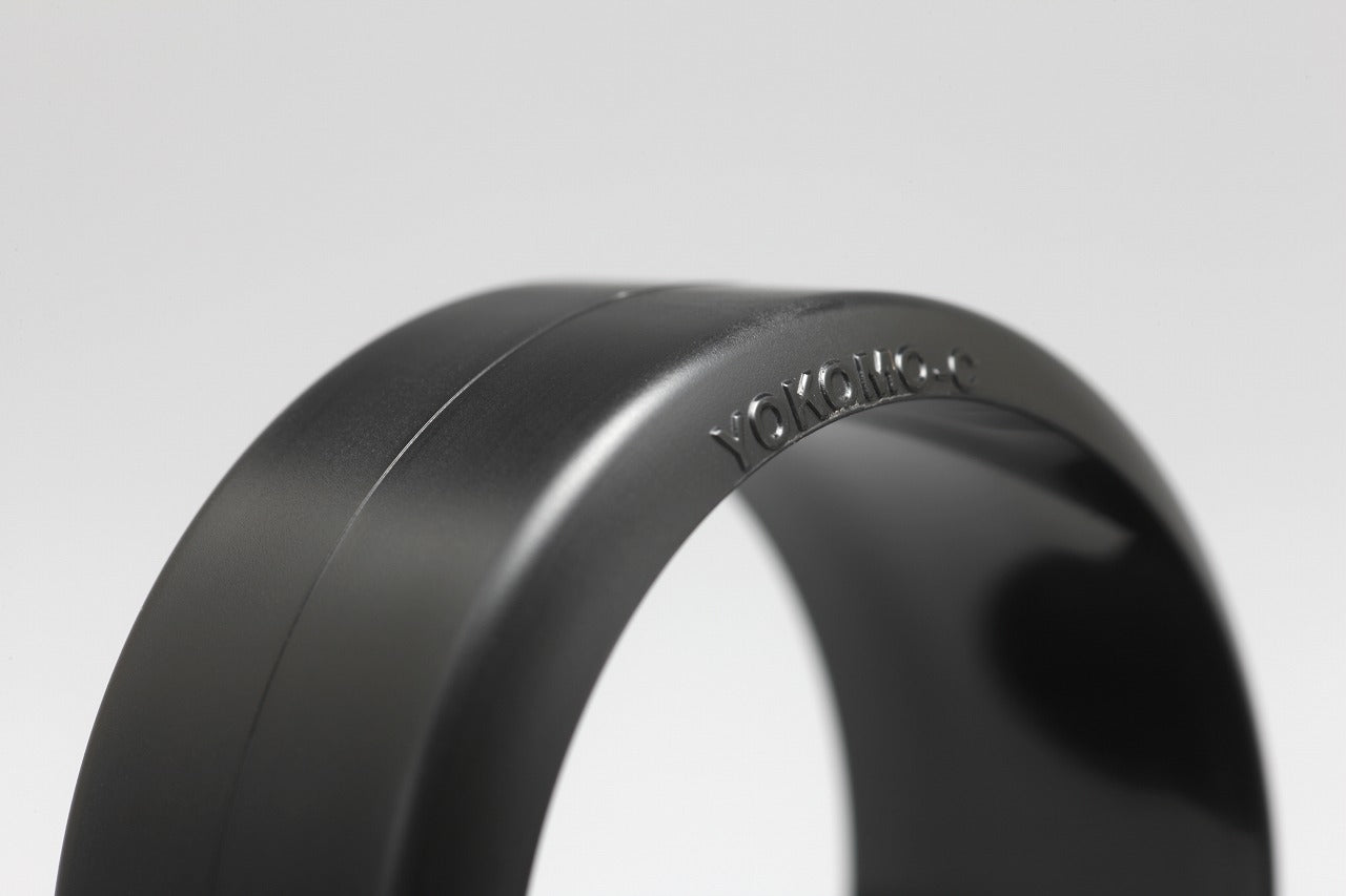 Close up of a DRC Drift Comp.Tire for Carpet Surface with the Yokomo logo in front of a white background