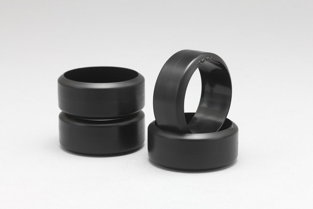 Four Yokomo DRC Drift Comp.Tire for Carpet Surface stacked on a white background