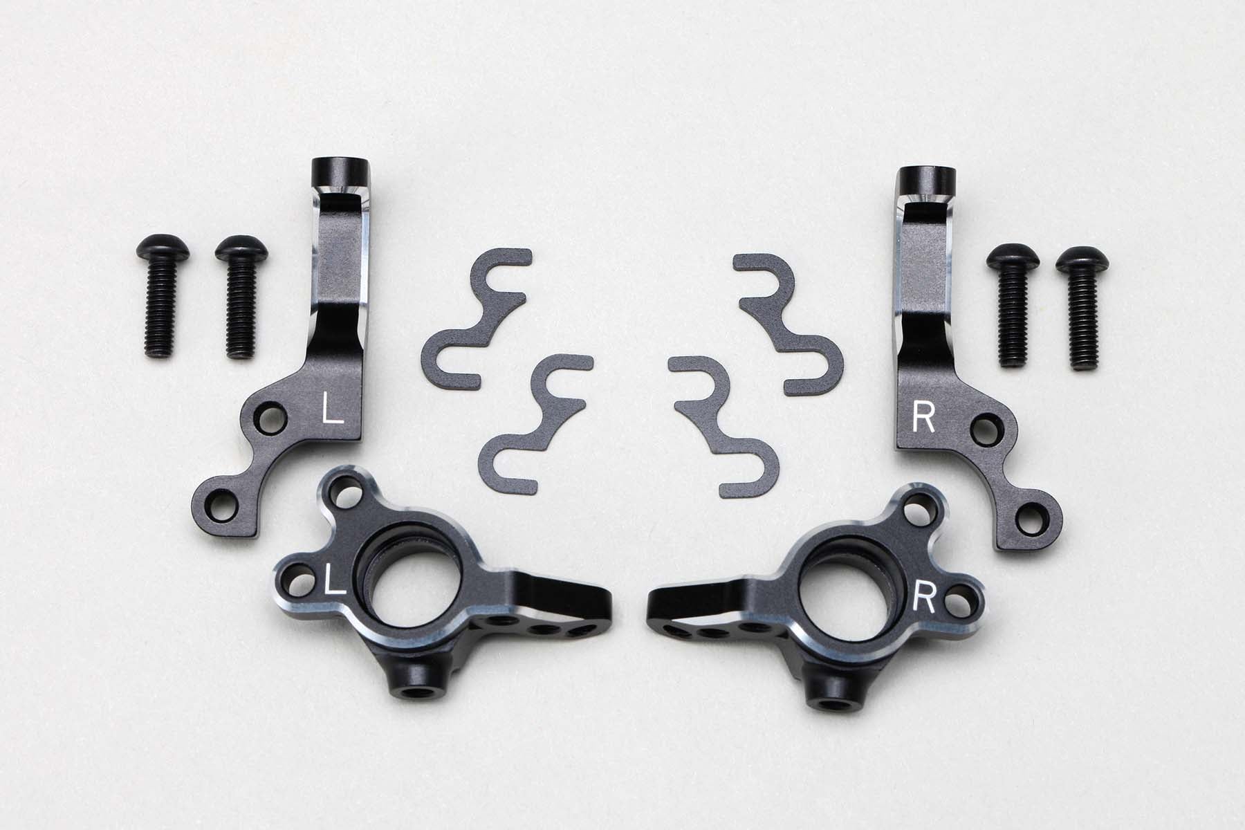 All the parts of the  L.W. Adjusta. Kingpin Angle ST Block for LTS by Yokomo sprawled on a white background