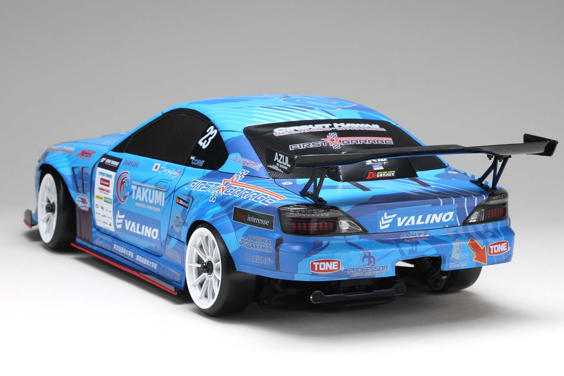 A fully constructed back view of the MERCURY SAYAKA SPECIAL S15 body w/Light Decal made by Yokomo on a grey background