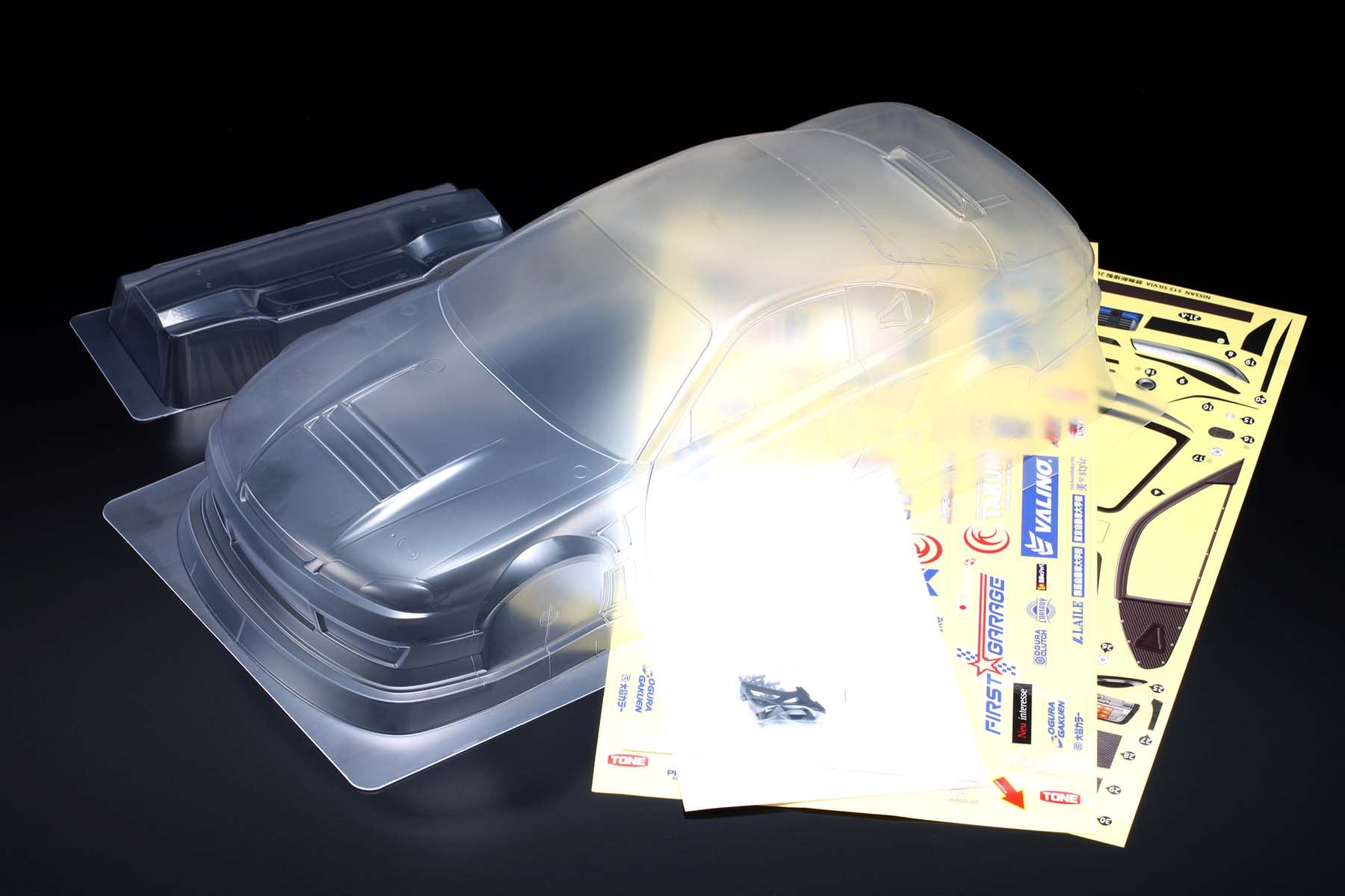 Clear plastic mold of the MERCURY SAYAKA SPECIAL S15 body w/Light Decal made by Yokomo with stickers on a black background