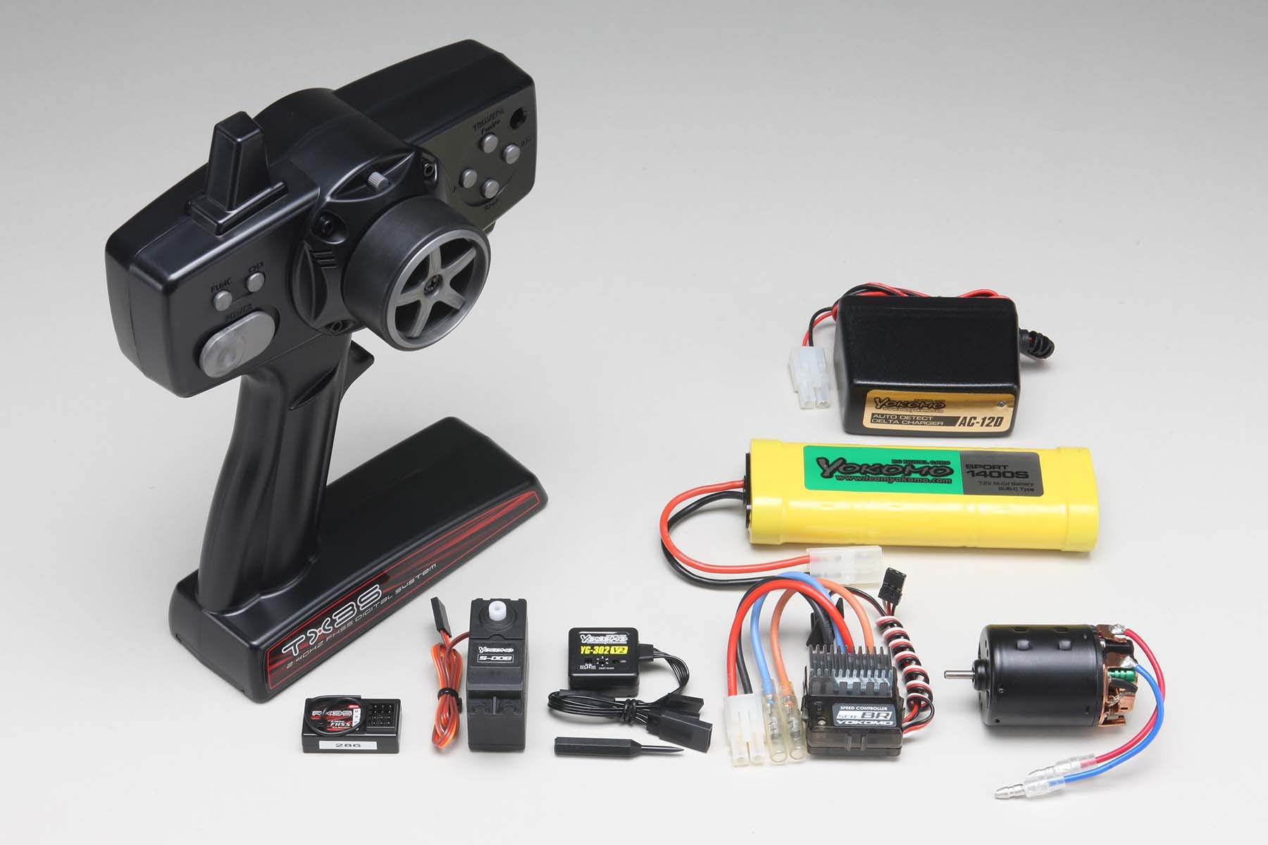 Full running Set w/2.4G-TX3S with YG-302V2 Gyro with all the individual parts on a white background