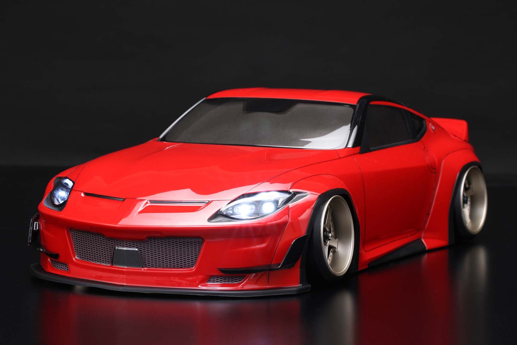 Front view of a fully assembled PANDEM NISSAN FAIRLADY Z RZ34 Body in red on a black background